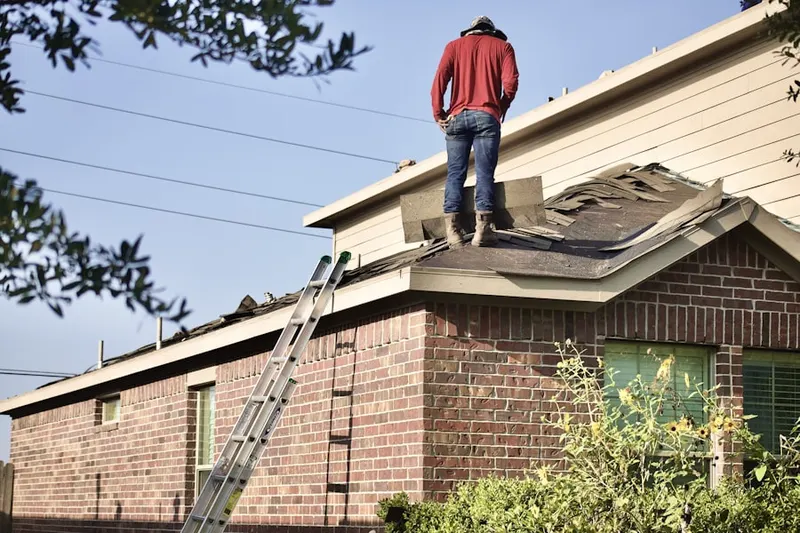 Professional roofer working on a residential roof in Interbay